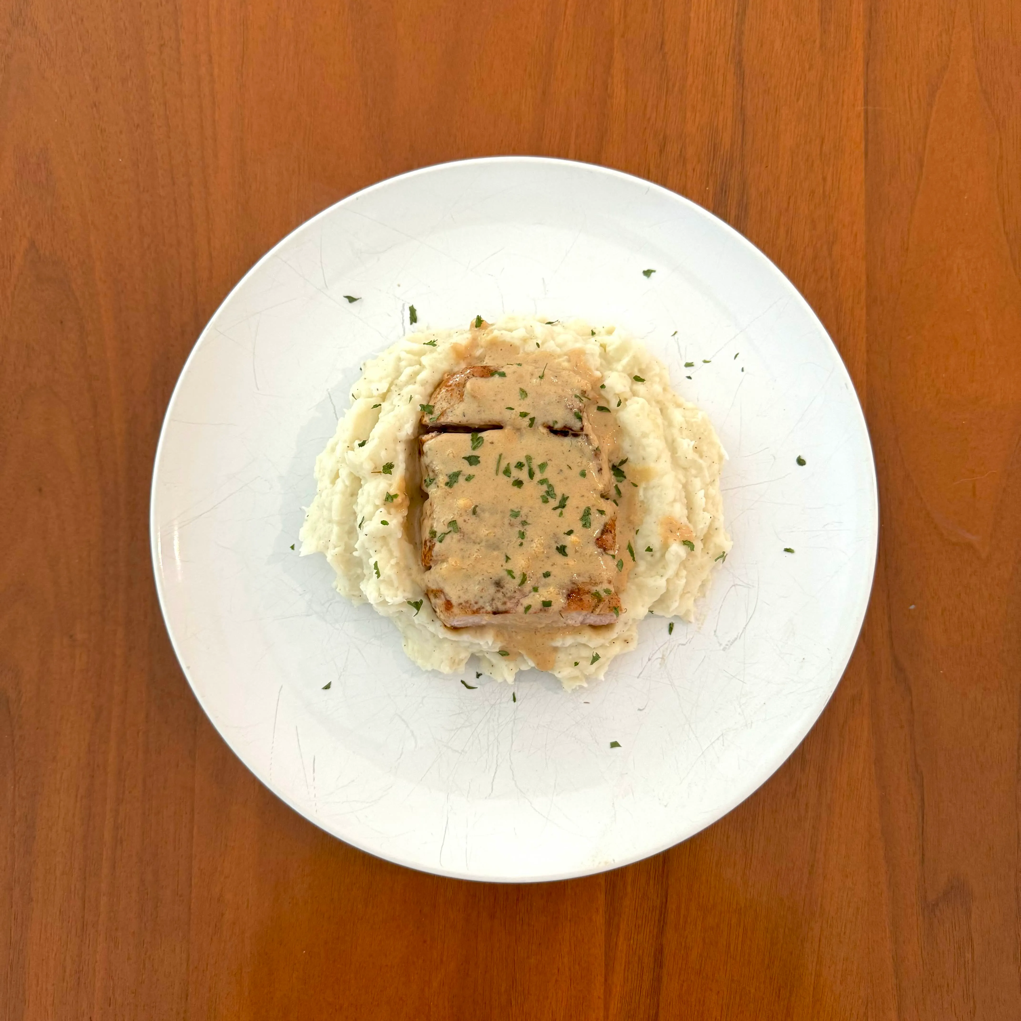 Top-down view of the same plate, the gravy pooling into the mash.